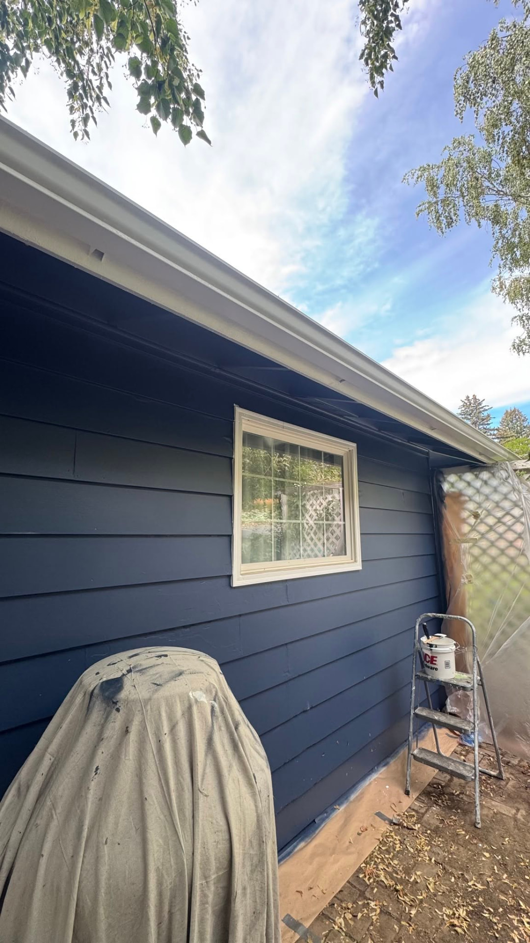 Freshly painted blue siding and white trim on a Wenatchee home